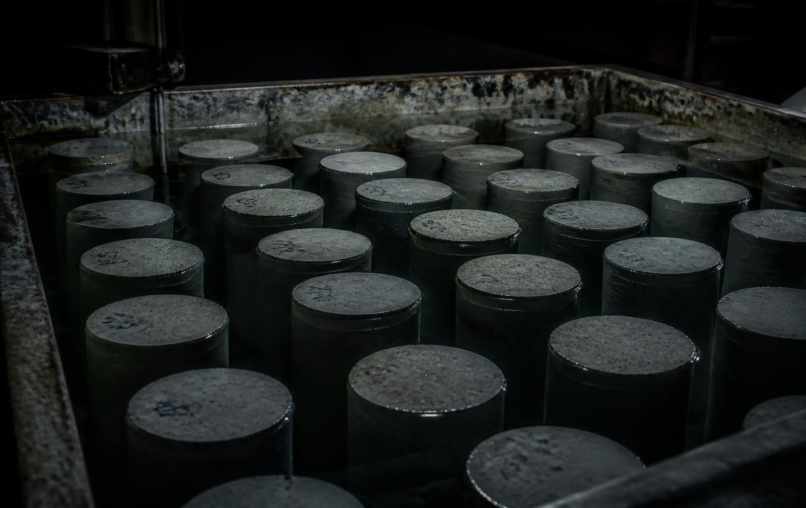 Corpos de prova cilíndricos curando em tanque de água no laboratório